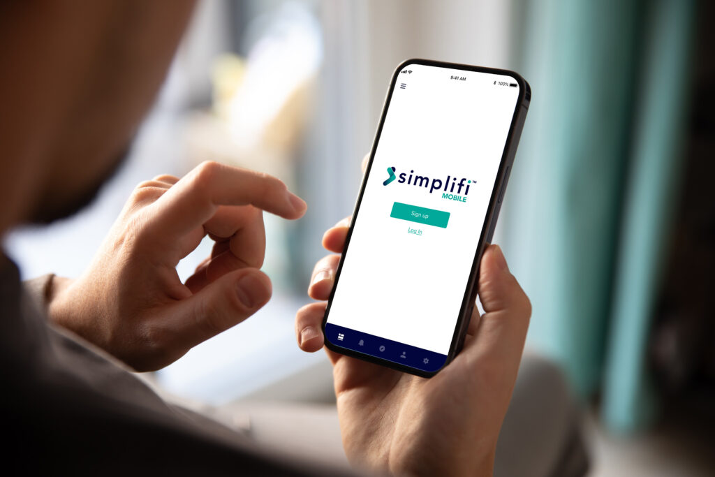 A user interacts with the Simplifi connectivity software app 